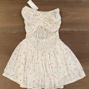 Super cute white romper with red hearts. Very cute!